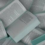 Open books laid one on top of another filling the scene.