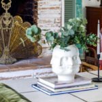 A welcoming living room scene showcasing a fireplace and a sleek white vase, perfect for relaxation and gatherings.
