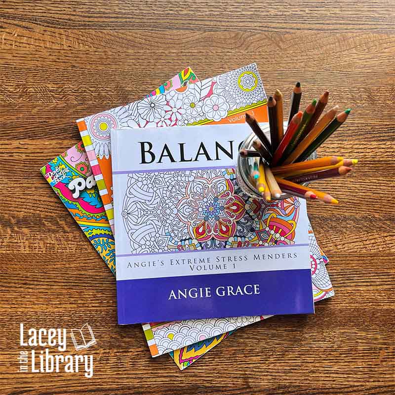 A cheerful arrangement of coloring books alongside a canning jar filled with colored pencils, inviting a moment of relaxation and enjoyment.