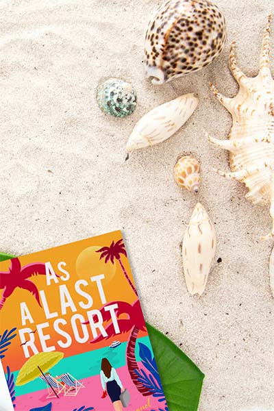 BR_AsALastResort_BeachyFlatlay beachy flatlay with the book As A Last Resort by Kristin Wollett near some seashells.