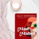 Mad Mabel near a cozy blanket and candle