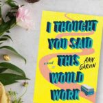 Flatlay of flowers, nest and tiny eggs with the book I Thought You Said This Would Work by Ann Garvin