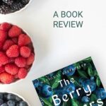 The Berry Pickers next to some bowls of berries.