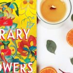 Oranges, a candle and half the cover of The Library of Flowers book