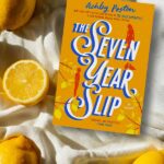 blanket with lemons and the book The Seven Year Slip by Ashley Poston