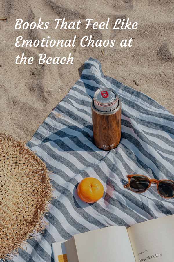Beach blanket with drink, orange, sunglasses, and beach hat