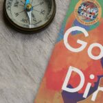 Antique compass and angled shot of Good Dirt by Charmaine Wilkerson.
