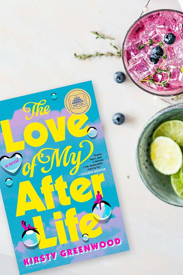 Flatlay of The Love of My Afterlife by Kirsty Greenwood next to summer cocktails